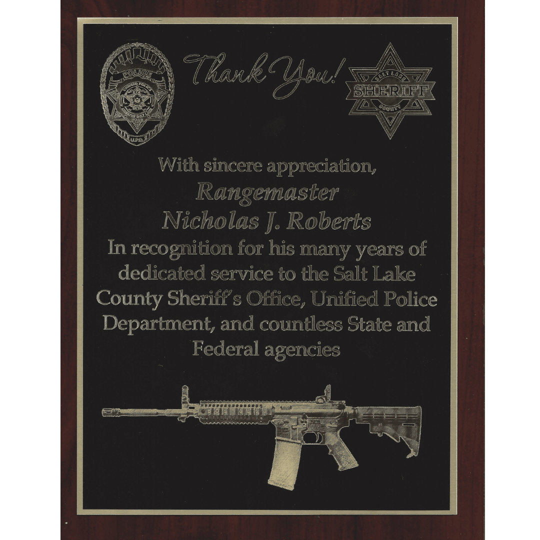 Appreciation plaque for Rangemaster Nicholas J. Roberts featuring police badges and a rifle graphic.