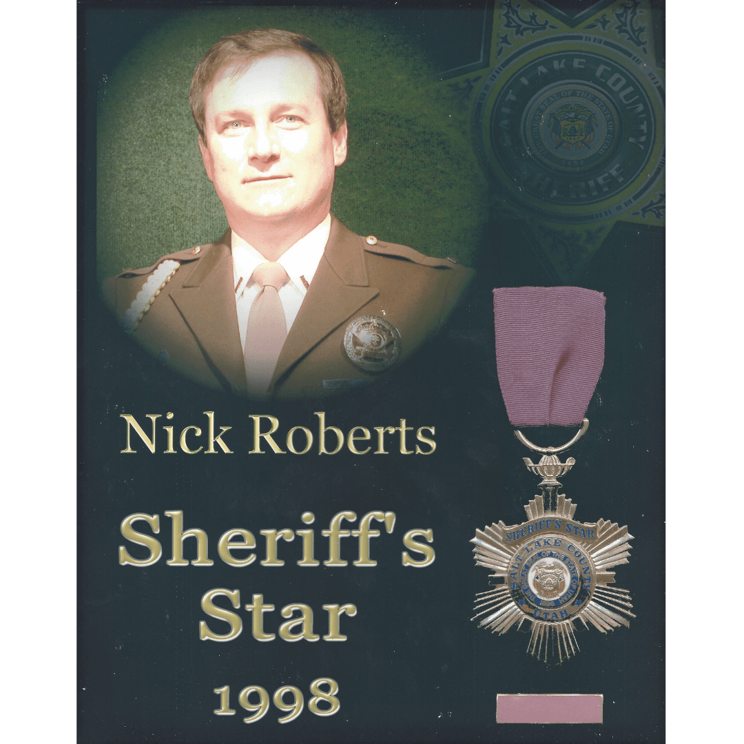 Portrait of Nick Roberts in uniform with his 1998 Salt Lake County Sheriff's Star.