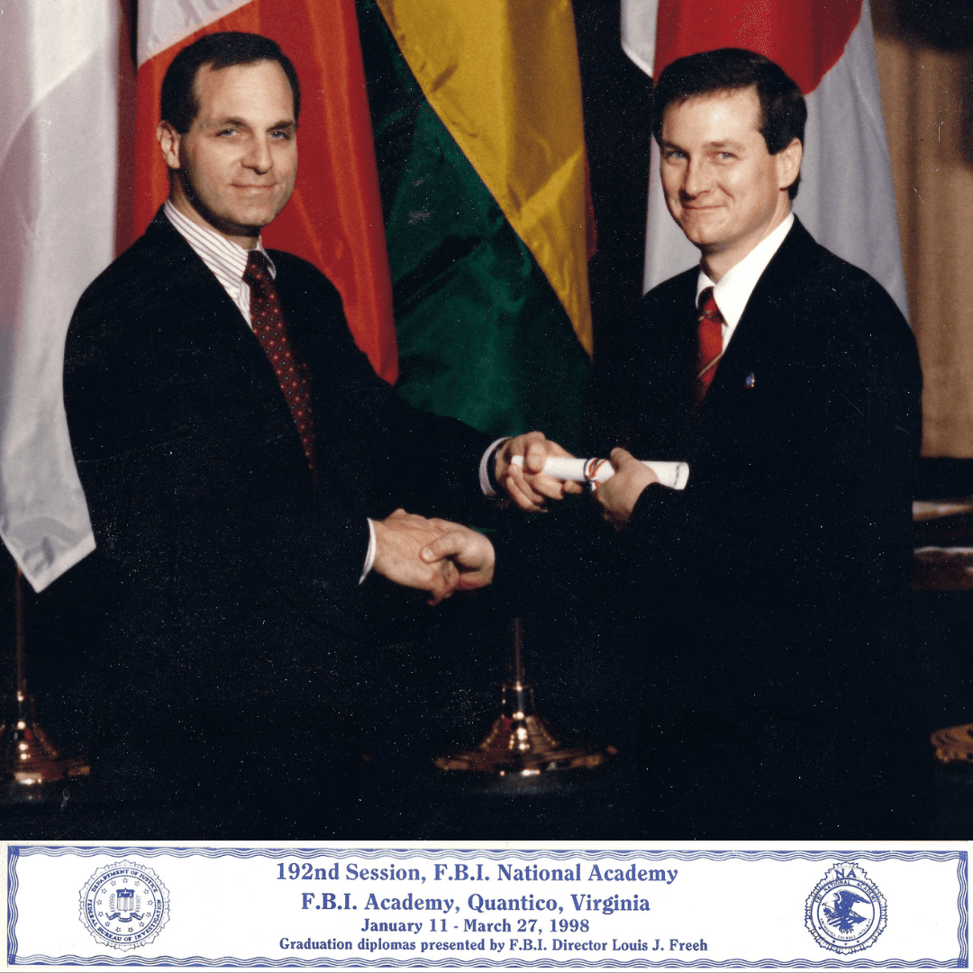 FBI Director Louis Freeh presents a diploma to a graduate at the 1998 academy ceremony.