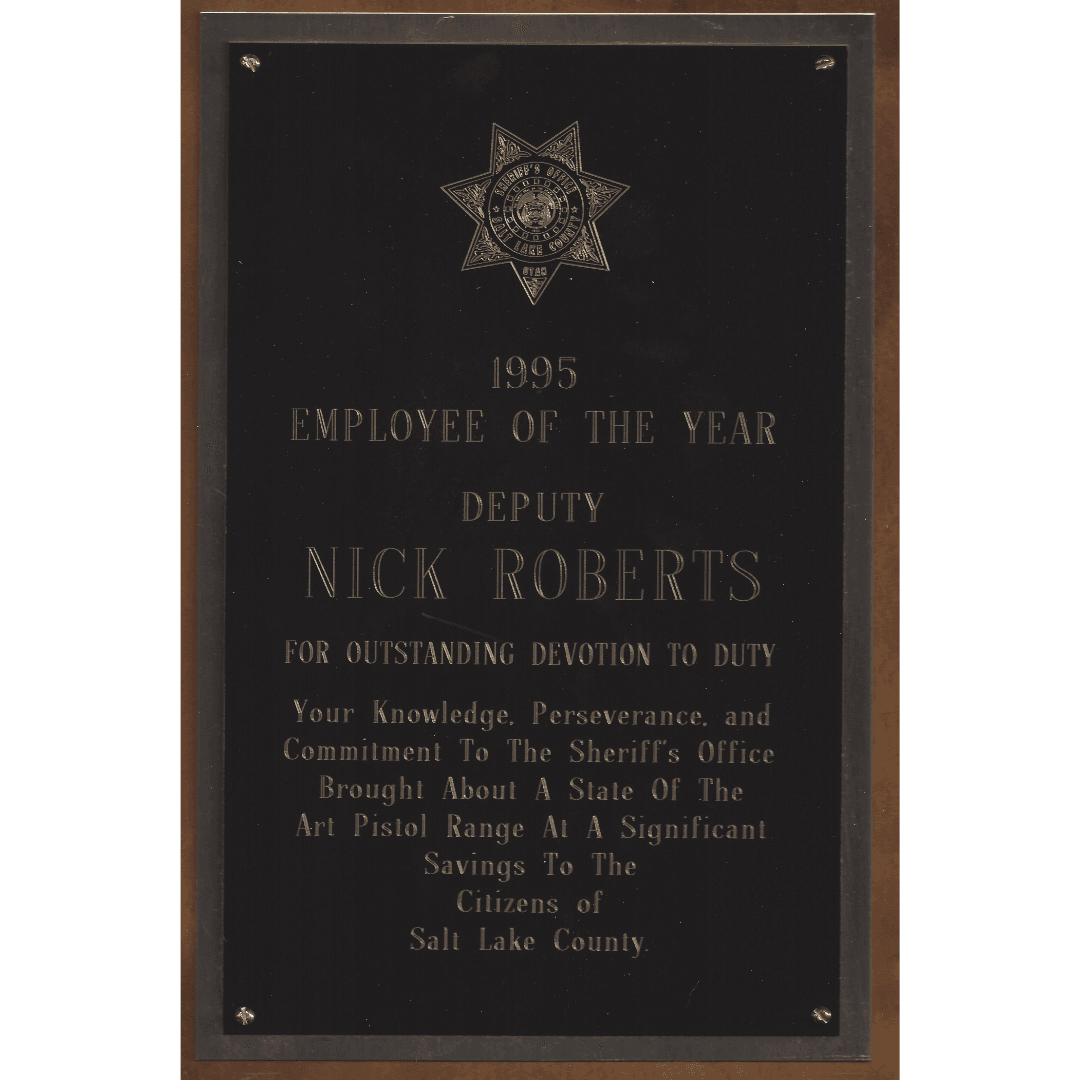 Black plaque honoring Deputy Nick Roberts as the 1995 Employee of the Year.